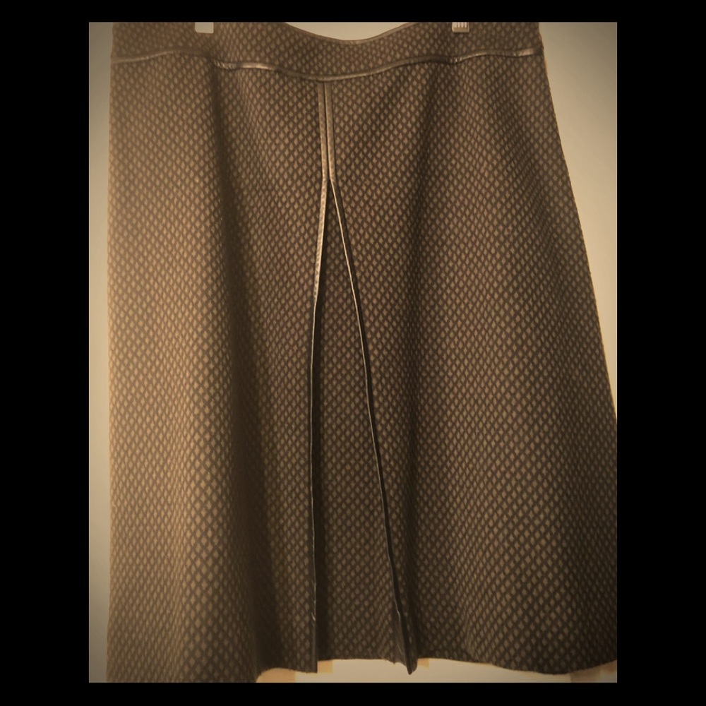 A line skirt with faux leather trim.